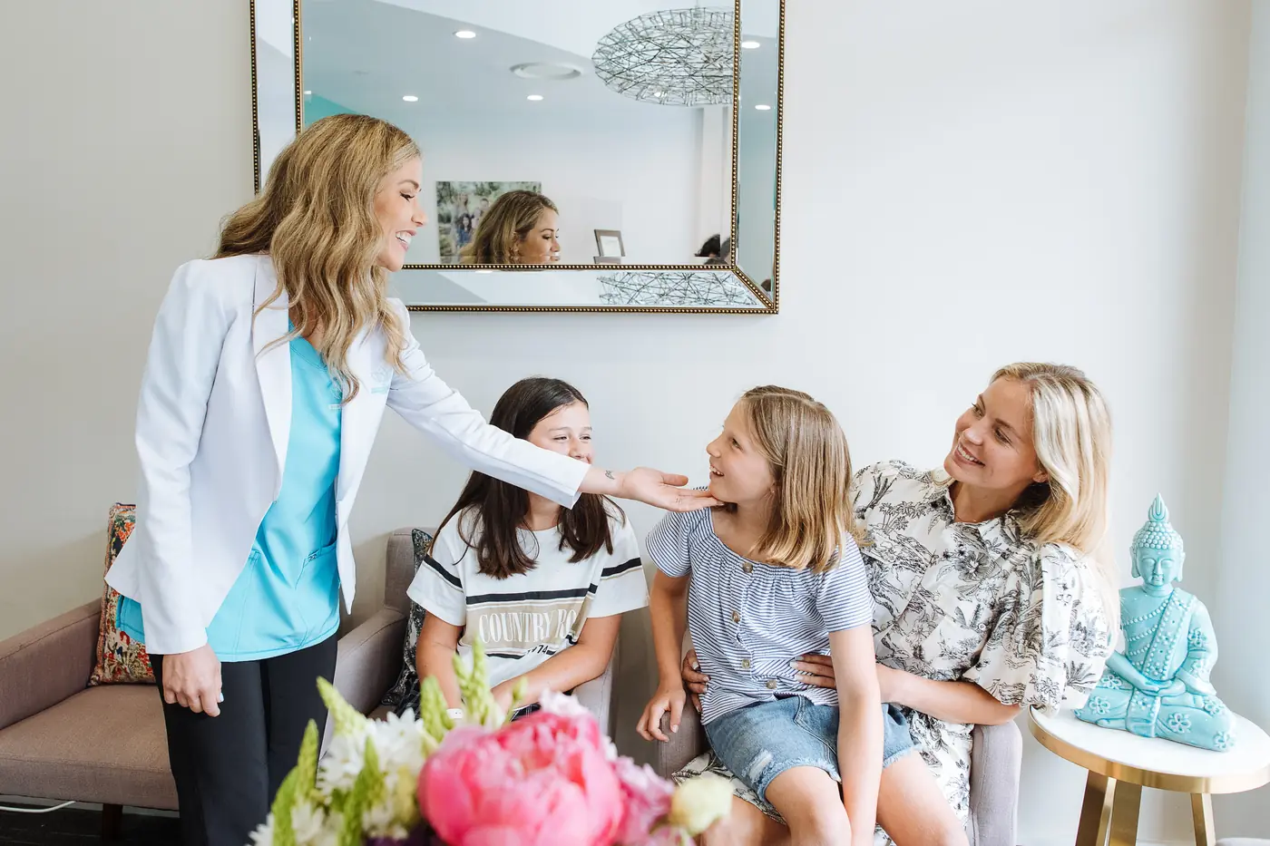 Dr Ellie Montero talking with a mother and her two daughters in the practice lounge